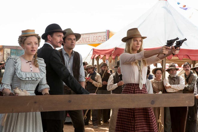 This image released by Universal Pictures shows, from left, Amanda Seyfried, Neil Patrick Harris, Seth MacFarlane and Charlize Theron in a scene from "A Million Ways to Die in the West." (AP Photo/Universal Pictures)