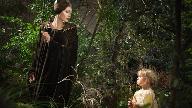 Angelina Jolie as Maleficent, left, in a scene with her daughter Vivienne Jolie-Pitt, portraying Young Aurora, in a scene from the film “Maleficent.”