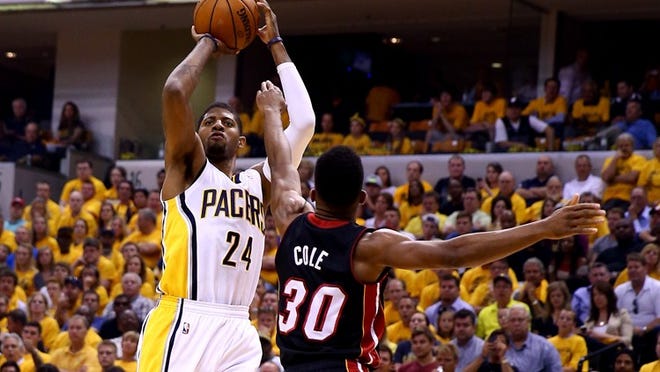 INDIANAPOLIS, IN - MAY 28: Paul George #24 of the Indiana Pacers takes a shot over Norris Cole #30 of the Miami Heat during Game Five of the Eastern Conference Finals of the 2014 NBA Playoffs at Bankers Life Fieldhouse on May 28, 2014 in Indianapolis, Indiana. NOTE TO USER: User expressly acknowledges and agrees that, by downloading and or using this photograph, User is consenting to the terms and conditions of the Getty Images License Agreement. (Photo by Andy Lyons/Getty Images)