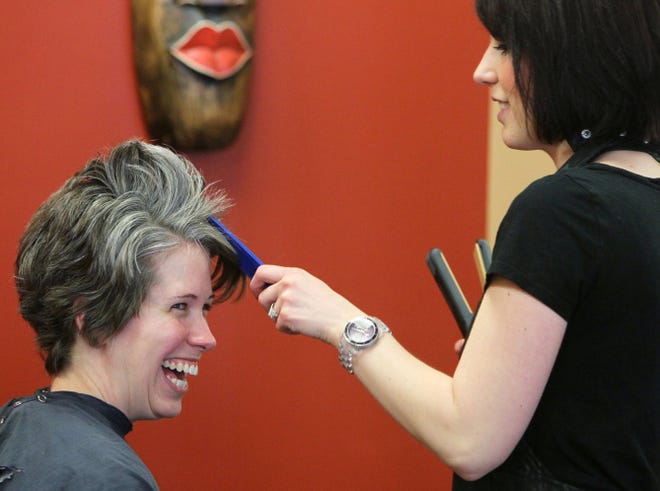 Michelle Touve-Holland, 34, is all smiles as stlyist Katie Guinan works on her hair at Gavin Scott Salon and Spa in Stow, Ohio.