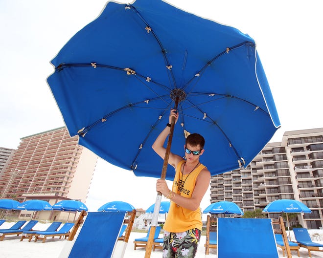 Daylin Pitts sets up an umbrella along Panama City Beach on Thursday.