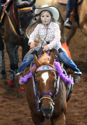 BRIAN D. SANDERFORD TIMES RECORD Rylan Stiles, 4, of Alma rides in the Grand Entry of the Old Fort Days Rodeo on Wednesday, May 28, 2014 at Kay Rodgers Park. Rylan's mother, Kemah Stiles, said she has been riding since the age of one, and that Rylan also competes in barrel racing. The park opens each night at 5 p.m.. with the Grand Entry at 7 p.m. There is a $2.00 ticket discount tonight for those donating a canned good or non-perishable food item.