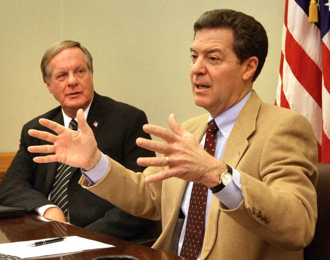 Gov. Sam Brownback and Kansas Revenue Secretary Nick Jordan, left, speaking at a 2012 news conference in which they characterized revenue shorfalls as a sign tax breaks are working.