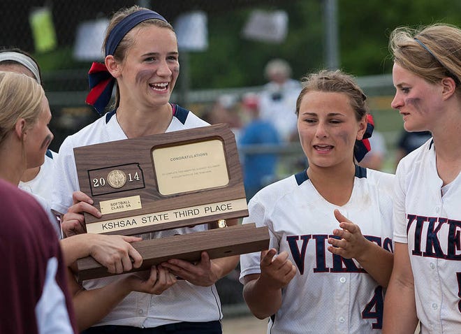 Rylee Neigenfind, Kylie Dillon and Dani Spence admire their state 5A third-place softball trophy on Friday at Twin Oaks in Manhattan. Seaman defeated Kapaun 14-3.