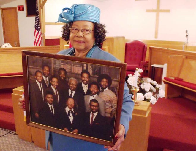 Leola Wakes holds a photo of herself with her late husband, the Rev. M.C. Wakes, and their nine sons. On Sunday evening, all nine sons will be in concert at Mount Carmel Missionary Baptist Church, 610 S.E. Lime.