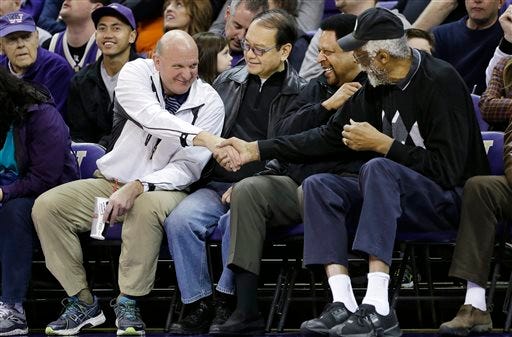 FILE - In this Jan. 25, 2014, photo, then-Microsoft CEO Steve Ballmer, left, shakes hands with former NBA players Bill Russell, right, and "Downtown" Freddie Brown as Omar Lee looks on during an NCAA college basketball game between Washington and Oregon State in Seattle. An individual with knowledge of negotiations to sell the Los Angeles Clippers said Shelly Sterling has reached an agreement to sell the team to Ballmer for $2 billion. The individual, who wasn't authorized to speak publicly, told The Associated Press on Thursday, May 29, 2014, that Ballmer and the Sterling Family Trust now have a binding agreement. The deal now must be presented to the NBA. (AP Photo/Elaine Thompson, File)