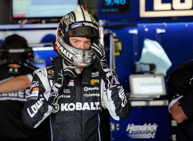 Jimmie Johnson adjusts his helmet during practice for the NASCAR Sprint Cup series auto race, Saturday, May 31, 2014, at Dover International Speedway in Dover, Del. (AP Photo/Nick Wass)