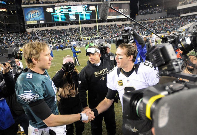 Quarterback Nick Foles (9), shown here shaking hands with Drew Brees (9) following the Eagles' season-ending loss to the Saints last January, put up some gaudy numbers last year. Now, he will try to do it as the anointed starting quarterback.