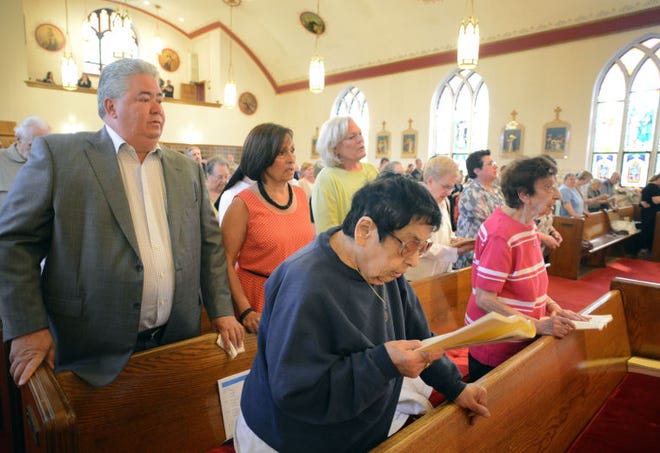 BRISTOL, PA - MAY 31: From left, Ralph DiGuiseppe, Monica DiGuiseppe, Robyn Trunell and in the foreground Ann Sidorak, all of Bristol, Pennsylvania continue worship after the closing of St. Ann's parish is announced May 31, 2014 in Bristol, Pennsylvania. The woman on the far right is unidentified. (Photo by William Thomas Cain/Cain Images)