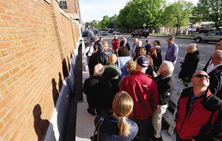 The Portsmouth Planning Board was joined by members of the community on a site walk of Portwalk on Thursday. The group is pictured at the brick wall on Maplewood Ave, which is one of the most-discussed issues.