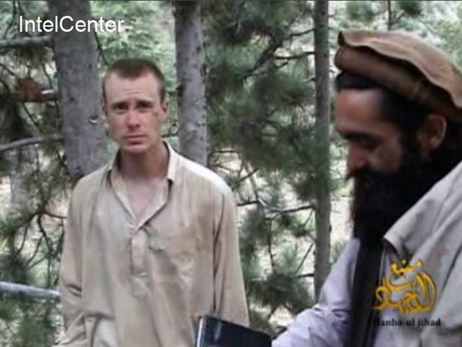 This file image provided by IntelCenter on Dec. 8, 2010, shows a frame grab from a video released by the Taliban containing footage of a man believed to be Bowe Bergdahl, left. Saturday, May 31, 2014, U.S. officials say Bergdahl, the only American soldier held prisoner in Afghanistan has been freed and is in U.S. custody. The officials say his release was part of a negotiation that includes the release of five Afghan detainees held in the U.S. prison at Guantanamo Bay, Cuba.
