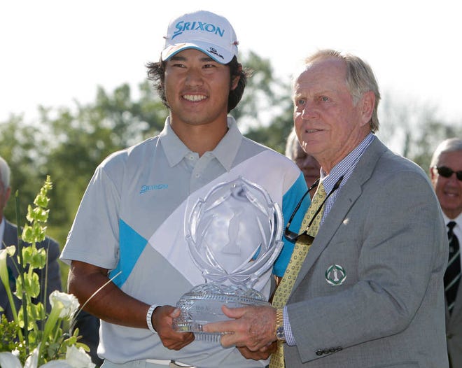 Jack Nicklaus, right, presents Hideki Matsuyama, of Japan, with the trophy after Matsuyama won the Memorial golf tournament on the first playoff hole Sunday, June 1, 2014, in Dublin, Ohio. (AP Photo/Jay LaPrete)