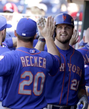 The Mets' Lucas Duda (right) celebrates with Anthony Recker after hitting a two-run home run against the Phillies in the 11th inning Sunday in Philadelphia. The Mets won 4-3.