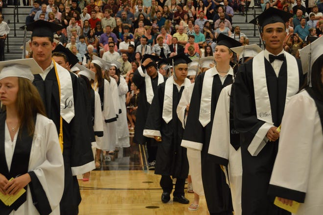 Seniors make their way into the gym for the West Ottawa High School commencement ceremony Sunday afternoon. Lisa Ermak/Sentinel Staff