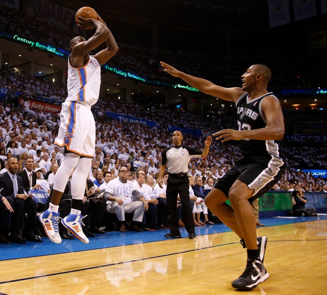 Oklahoma City's Serge Ibaka (9) shoots a 3-pointer over San Antonio's Boris Diaw (33) during Game 6 of the Western Conference Finals in the NBA playoffs between the Oklahoma City Thunder and the San Antonio Spurs at Chesapeake Energy Arena in Oklahoma City, Saturday, May 31, 2014. Photo by Bryan Terry, The Oklahoman