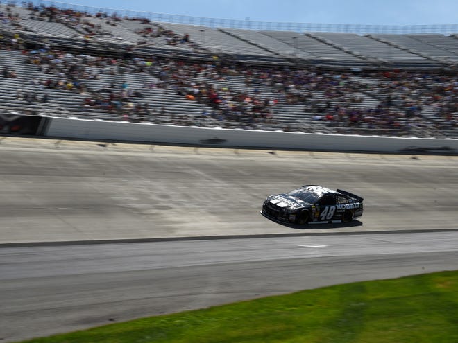Winner Jimmie Johnson drives past many empty seats during Sunday's Sprint Cup race in Dover, Del.