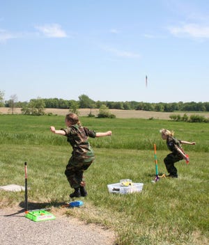Civil Air Patrol cadets Rowan Starkweather and Kirsten Hillabrandt launch stomp rockets as part of an educational demonstration for Emerson Elementary School students.