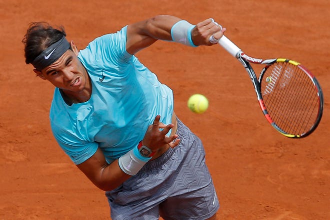 Spain's Rafael Nadal serves the ball during the fourth round match of the French Open tennis tournament against Serbia's Dusan Lajovic at the Roland Garros stadium, in Paris, France, Monday, June 2, 2014. THE ASSOCIATED PRESS