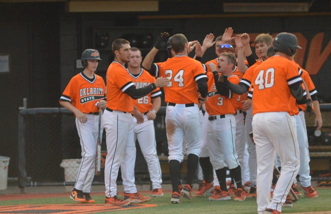 OSU’s Connor Costello (24) and his teammates celebrate his two-run home run in the sixth inning Sunday at Allie P. Reynolds Stadium. 
          Photo by JACKIE DOBSON, Tulsa World