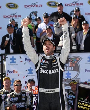 AP PHOTO
Jimmie Johnson celebrates winning the NASCAR Sprint Cup series auto race Sunday at Dover International Speedway in Dover, Del.