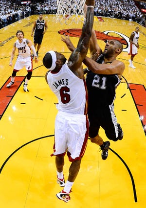 The Miami Heat's LeBron James (6) moves the ball against San Antonio Spurs' Manu Ginobili (20) during the first half in Game 7 of the NBA basketball championships, Thursday, June 20, 2013, in Miami. (AP Photo/Lynne Sladky)