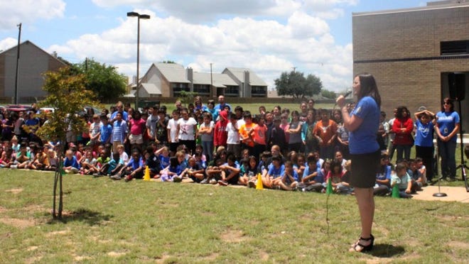 Bluebonnet Elementary School Principal Gabi Niño speaks to the school’s students at the groundbreaking ceremony of the new outdoor learning facility Thursday.