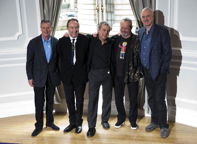 In this Thursday, Nov. 21, 2013, file photo the surviving members of the Monty Python comedy group, from left, Michael Palin, Eric Idle, Terry Jones, Terry Gilliam and John Cleese pose for photographers during a photocall to promote a reunion stage show they are going to perform together, at a hotel in London.