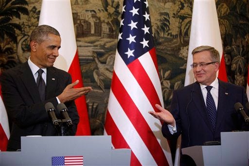 U.S. President Barack Obama and Poland's President Bronislaw Komorowski gesture towards each other at a news conference at Belweder Palace in Warsaw, Poland, Tuesday.