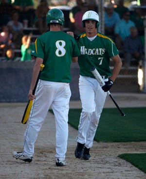 Idalou's Kleat Smith is greeted by Callan Johnson after scoring a run against Wall during their Class 2A region final on Wednesday in Snyder. (Shannon Wilson / AJ Media)
