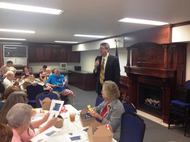 Duane Goossen, former state budget director, addresses members of the League of Women Voters on Tuesday at McCrite Plaza retirement community.