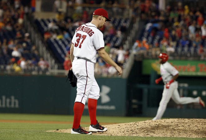 Washington Nationals starting pitcher Stephen Strasburg walks back to the mound as Philadelphia Phillies' John Mayberry Jr., rounds the bases for his two-run homer during the seventh inning Wednesday night. (AP Photo/Alex Brandon)