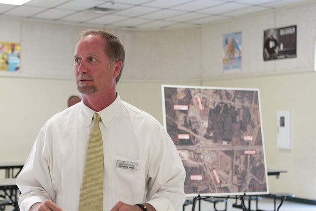 Richard Holt of Sain Associates stands in front of a map as he listens to a question from the audience gathered at E.A. Cox Middle School Tuesday evening to discuss plans to upgrade the interchange at Interstate 65 and Bear Creek Pike. (Staff photo by Rebecca Croomes)