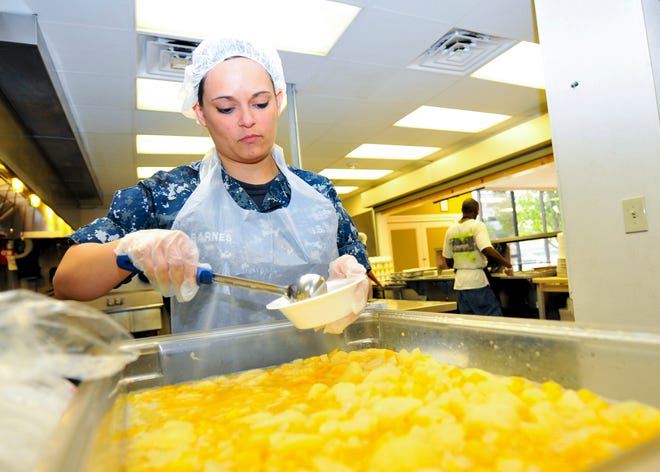 YN1(AW) Angel Barnes prepares fruit bowls at a Commander, Navy Region Southeast (CNRSE) volunteer event at the City Rescue Mission. During the event, CNRSE Sailors and civilians served more than 300 hot meals to the homeless.