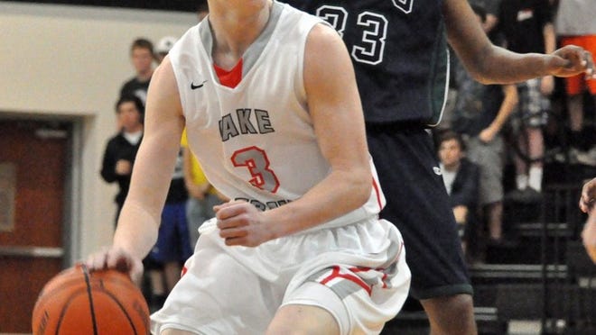 Tate Searle keeps an eye out for a lane to the basket early in Lake Travis’ 59-49 playoff win over McNeil. Searle struggled with his outside shot but scored 13 points on a bevy of drives to pace the Lake Travis attack.