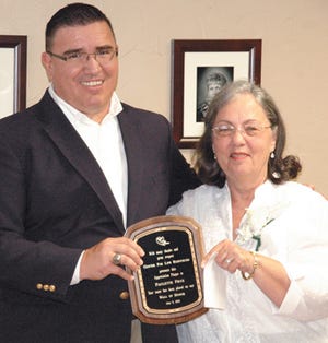 Dion White, CEO for the Center for Life Resources, presented long-time employee and volunteer Paulette Frye with a plaque at a Thursday event in her honor.