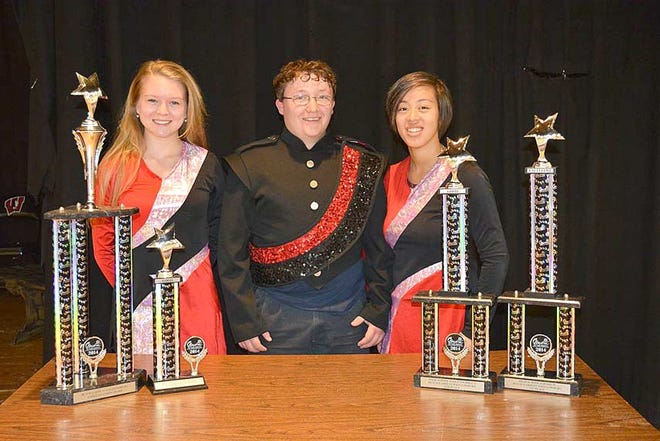 Posing with trophies received at Music in the Parks in Williamsburg, Virginia are, from left, Adrienne Perron (color guard captain), Brandon Cox (drum major), and Emilee Wooldridge (color guard captain).