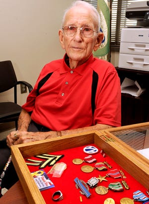 WWII veteran A.C. Boyd is seen with his medals at the RSVP office, Wednesday, June 4, 2014, in Gadsden, Ala. Boyd is 90 years old and volunteers with RSVP and Gadsden Regional Medical Center and delivers MANNA meals.