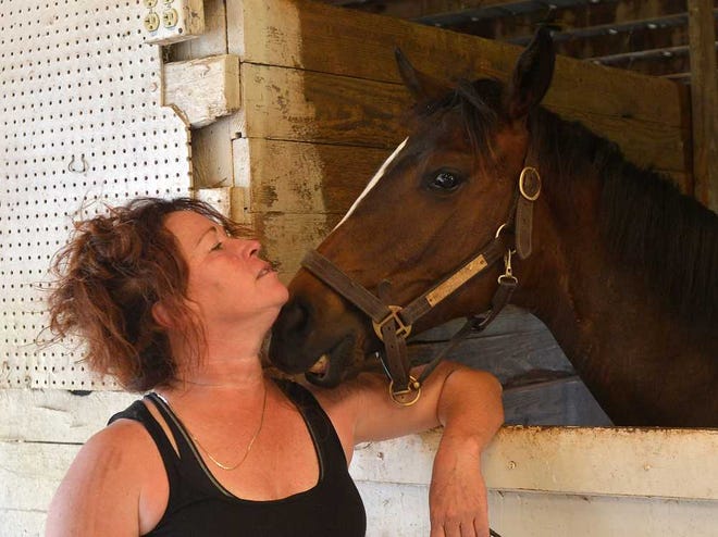 Trainer Susan Kemp shares a moment with Classic Ride at Morgan Diamond M Stables in Athens, Ga. on Thursday, June 5, 2014.   (Richard Hamm/Staff) OnlineAthens / Athens Banner-Herald
