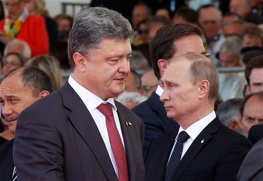 Ukraine's President-elect Petro Poroshenko, left, walks past Russian President Vladimir Putin during the commemoration of the 70th anniversary of the D-Day in Ouistreham, western France, Friday, June 6, 2014. World leaders and veterans gathered by the beaches of Normandy on Friday to mark the 70th anniversary of World War Two's D-Day landings. (AP Photo/Christophe Ena, Pool)