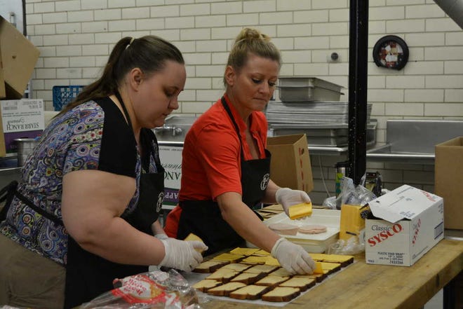 Mollie Bryant / Amarillo Globe-News From left, Christy Coffman and Kelley Reisinger prepare sandwiches for the city of Amarillo summer lunch program. For the first time, the program will provide free lunches to children for the entire summer.