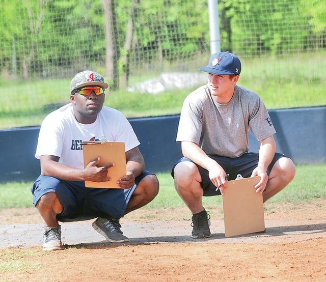Fourth-year Doenges Ford Indian head coach/manager Anthoney Towers, left, and American Legion assistant coach Matt Hoelting confer during last month’s Legion baseball tryouts, held at the Oklahoma Wesleyan University field. Mike Tupa/Examiner-Enterprise