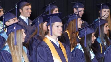 Graduating seniors listen during the school’s graduation.
