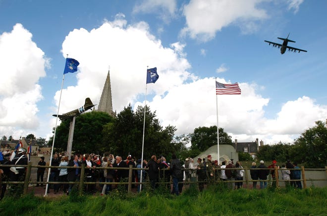 A C130 plane flies above Picauville, during a ceremony in homage to the English and American airborne and pilots, at the Memorial of airborne and US Air Force, in Picauville, France, as part of the commemoration of the 70th D-Day anniversary, Thursday, June 5, 2014. World leaders and veterans prepare to mark the 70th anniversary of the invasion this week in Normandy. THE ASSOCIATED PRESS