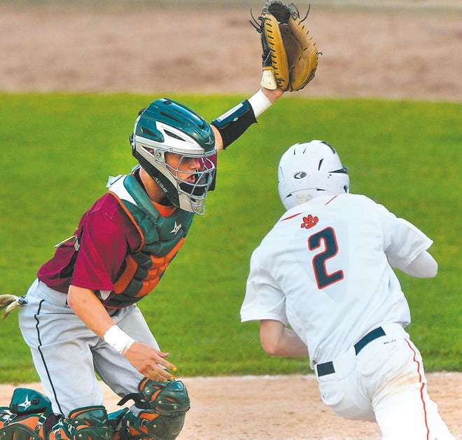 Westmont catcher Joe Donovan can't make the tag on Tyler Nunez (2) of Byron during the 6th inning of Friday's IHSA Class 2A semifinal game.