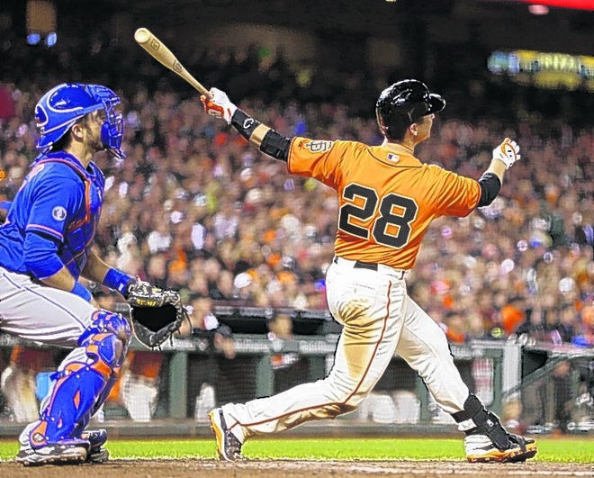 Giants' Buster Posey follows through after launching a two-run home run off Mets' Carlos Torres in the eighth inning.
