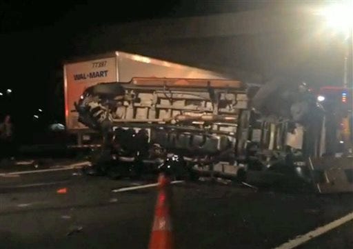 In this image from video the limousine bus carrying Tracy Morgan and six other people lies on it's side early Saturday morning June 7, 2014 on the New Jersey Turnpike. Morgan remained hospitalized as state and federal officials continued their investigation of the six-vehicle crash on the New Jersey Turnpike that took the life of a Morgan friend and left two others seriously injured, authorities say. (AP Photo/Will Vaultz Photography)