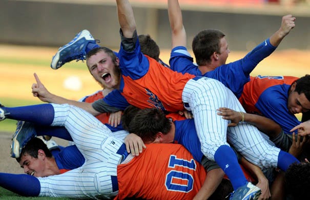 Whiteville players celebrate their Class 1A state baseball championship against East Surry at Five County Stadium in Zebulon on Saturday, June 7, 2014.