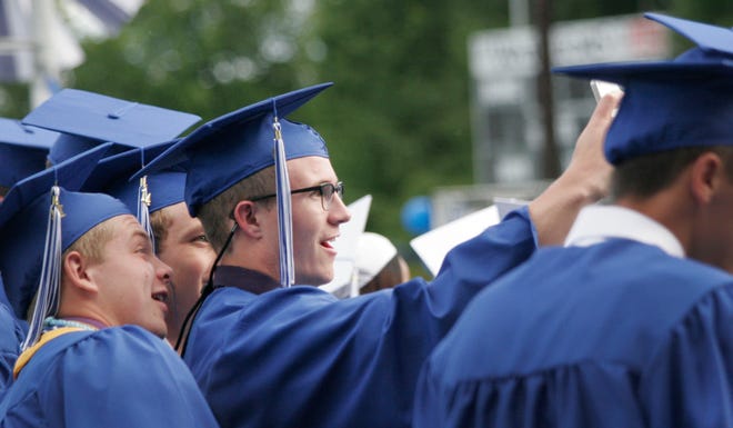 Bryce Mosher, right, snaps a selfie with friends Jacob Rader and Peter Edwards, while waiting for Narragansett Regional High School's graduation to begin.