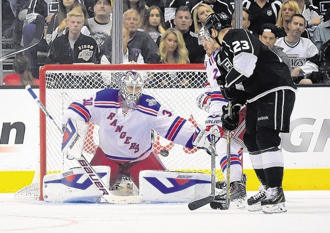Kings' Dustin Brown, right, scores on Rangers goalie Henrik Lundqvist during the second overtime in Game 2.