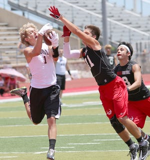 Brownwood’s Rylee Gregory (1) hauls in a pass over the arms of an outstretched West defender during the Lions’ 44-27 semifinal victory Saturday in Glen Rose that secured a spot in the 7-on-7 Division II state tournament.